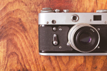 Vintage camera on wooden background