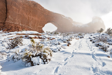 Window Arch Utah in winter path and footprints