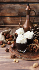 hot chocolate in glass cups and cream with nuts
