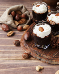 hot chocolate in glass cups and cream with nuts