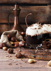 hot chocolate in glass cups and cream with nuts