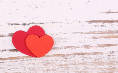 Valentine's Day background. Two paper hearts on wooden background