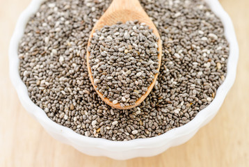 chia seeds with wooden spoon.