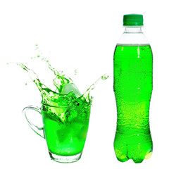 Splashing of green soda with ice in glass on white background.