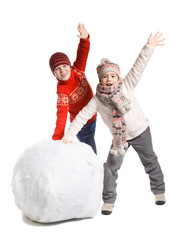 Children make a snowman in winter time, isolated