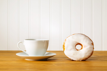Fototapeta na wymiar White donut with coffee on a wooden table