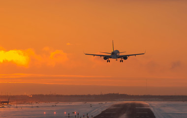Airplane landing to sunset