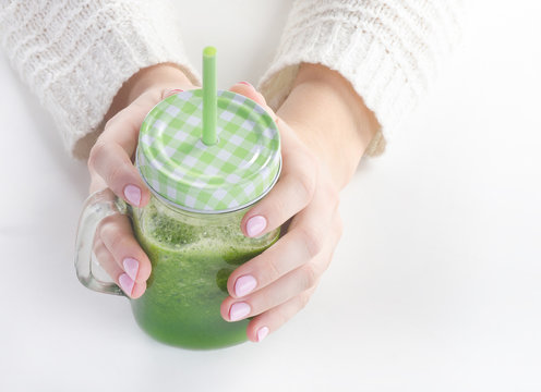 Woman hands holding Green detox smoothie