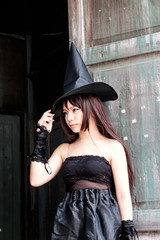 Beautiful Asian woman in witch costume for Halloween concept