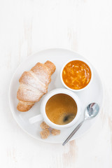 traditional breakfast with coffee and fresh croissants, vertical
