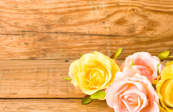 Roses flowers on wood, floral background on a vintage wooden planks useful as greeting card