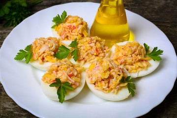 Eggs stuffed with crab and cheese on a wooden table