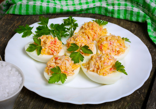 Eggs stuffed with crab and cheese on a wooden table