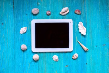 time to rest, tablet, seashells, blue wood background,