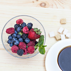Summer berries (strawberries, raspberries, blueberries, blackberries) and a cup of coffee 