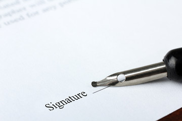 A business contract is a closeup of the signature