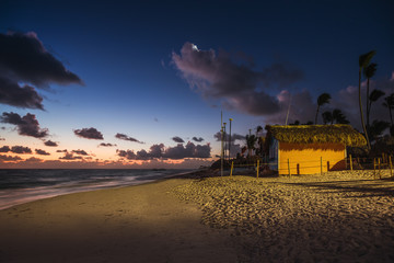 Mystic sunrise with moon and stars over the sandy beach in Punta