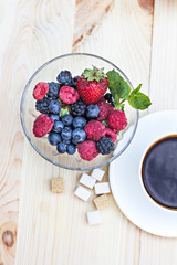 Summer berries (strawberries, raspberries, blueberries, blackberries) and a cup of coffee "espresso". A healthy breakfast, snack.