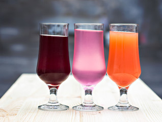 Fresh colorful lemonade (pink, purple, orange)  in glasses
