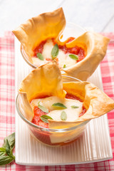 creative little lasagne on glass bowl, selective focus