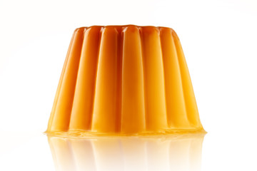 Juicy udding or creme caramel isolated over white background.