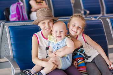 Happy kids waiting for flight inside airport