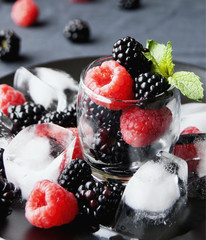 black berries and raspberries in a glass cup