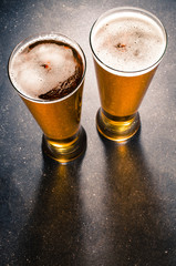 Beer glasses on dark table