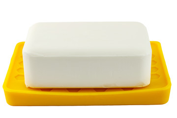 White soap on yellow holder isolated on white background