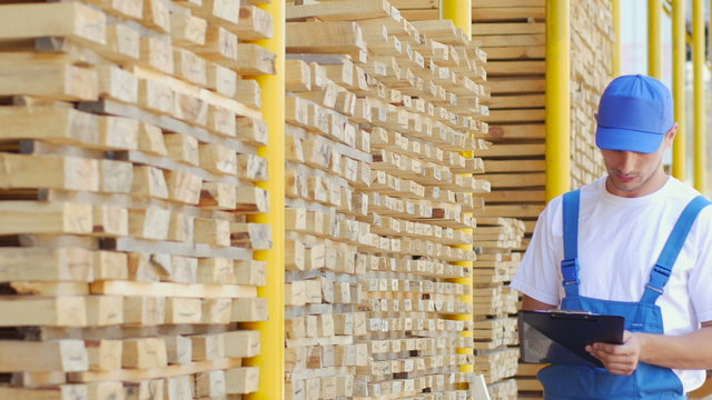 The employee of construction shop does notes in the form