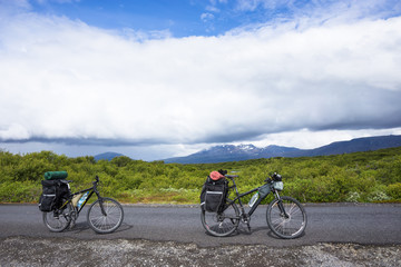 Fototapeta na wymiar Biker rides on road at sunny summer day in Iceland
