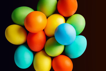 Bright colored Easter eggs on dark background. Isolated with clipping path. Top view.