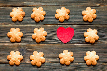 Butter biscuits brown color in the form of a flower on a dark ba