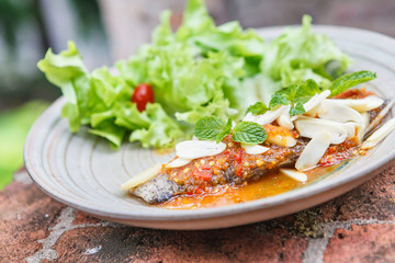 Thai food style : Fried fish toppted with chilli sauce.