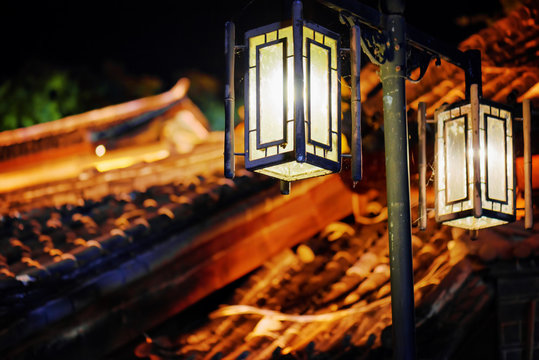 Night view of street lamp and traditional Chinese tile roofs