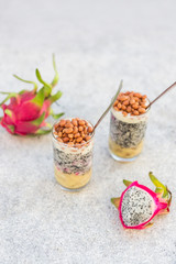 Dragon fruit juice smoothies with nuts and banana cocktail in a glass on the table