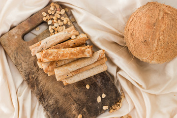 nuts and coconut waffles on a cutting board and silk fabric food