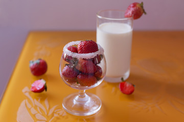 Strawberry in a glass of milk breakfast fruit with sugar