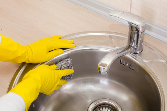 Woman Cleaning Kitchen Sink