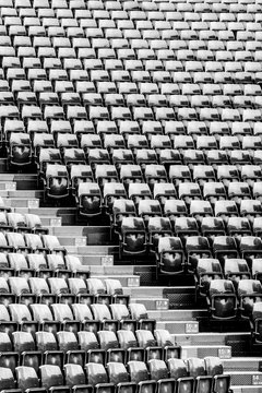 Row of seats black and white image at stadium background and texture.