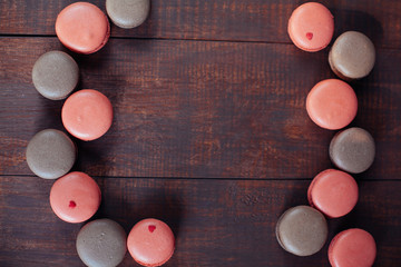 Sweet and colourful french macaroons on a wooden background. foc
