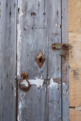 Old weatherd doorwith rusty lock