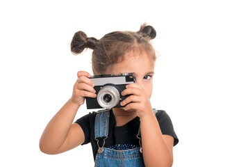 Baby girl  with vintage camera  posing  in studio.Isolated