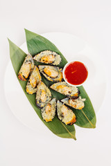 mussels baked with sauce on a tropical leaves for restaurant menu