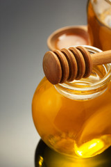 glass jar of honey on black