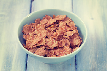 cereals in blue bowl on blue wooden background