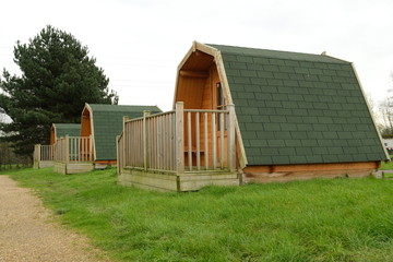 Fototapeta na wymiar Wooden cabins at camping site in Lee Valley Park