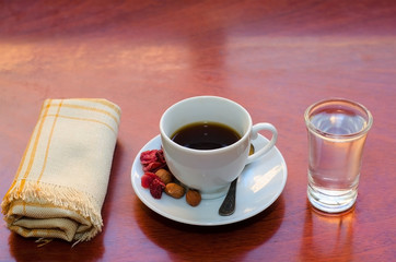 Espresso. White cup of coffee with glass of water