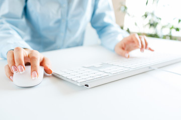 Woman office worker typing on the keyboard