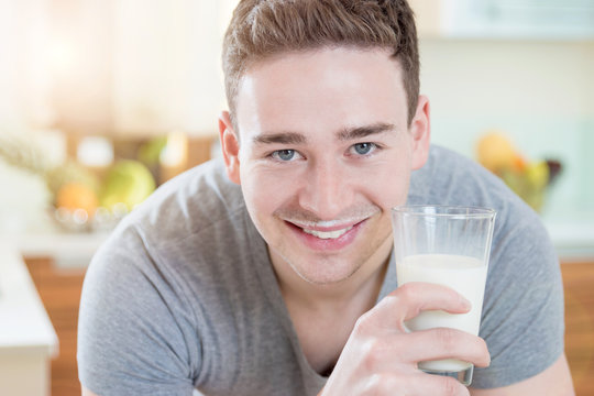 Smiling Man with a glass of Milk in the Morning Sun